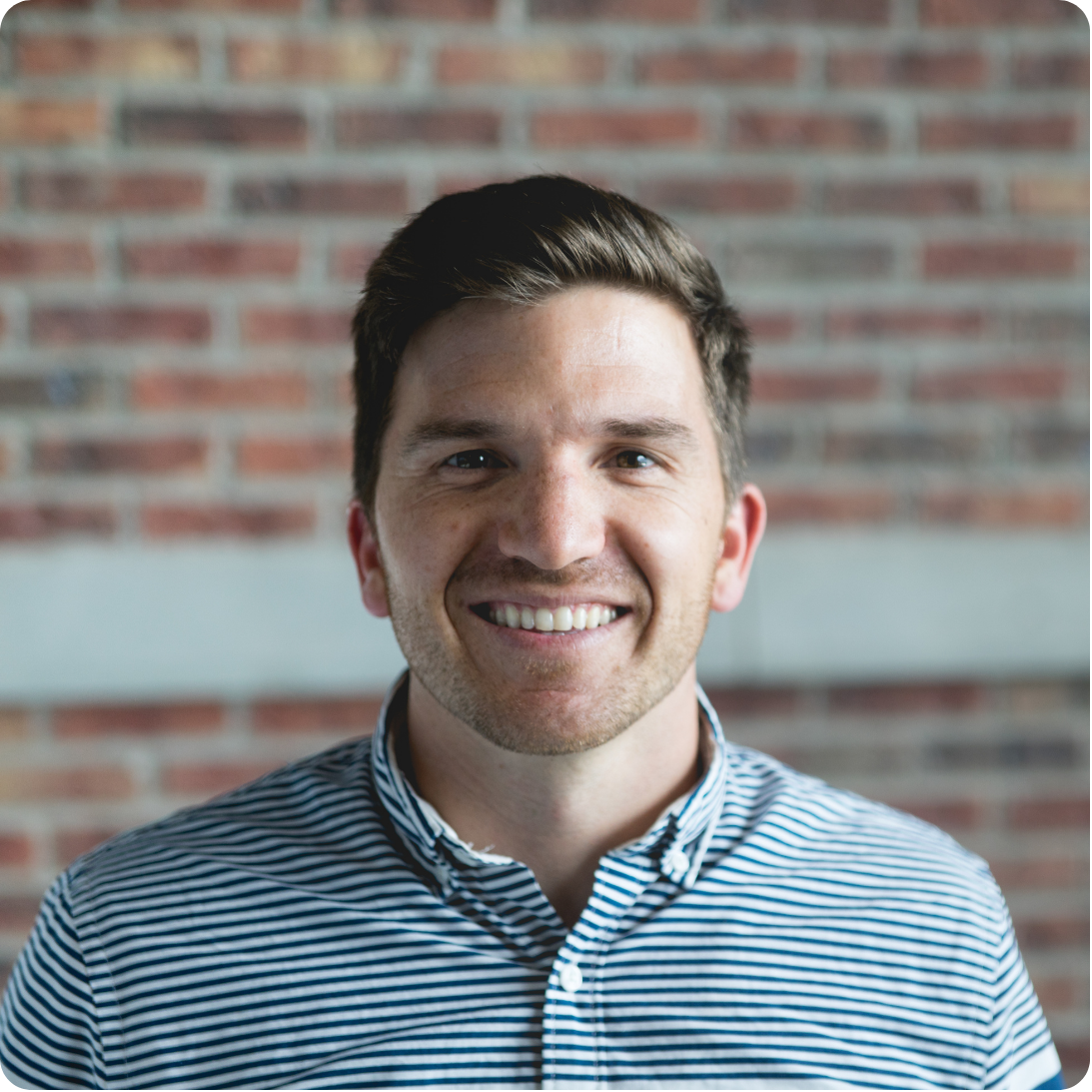 Portrait of the Professional Colleague persona, a man in a striped button-down shirt