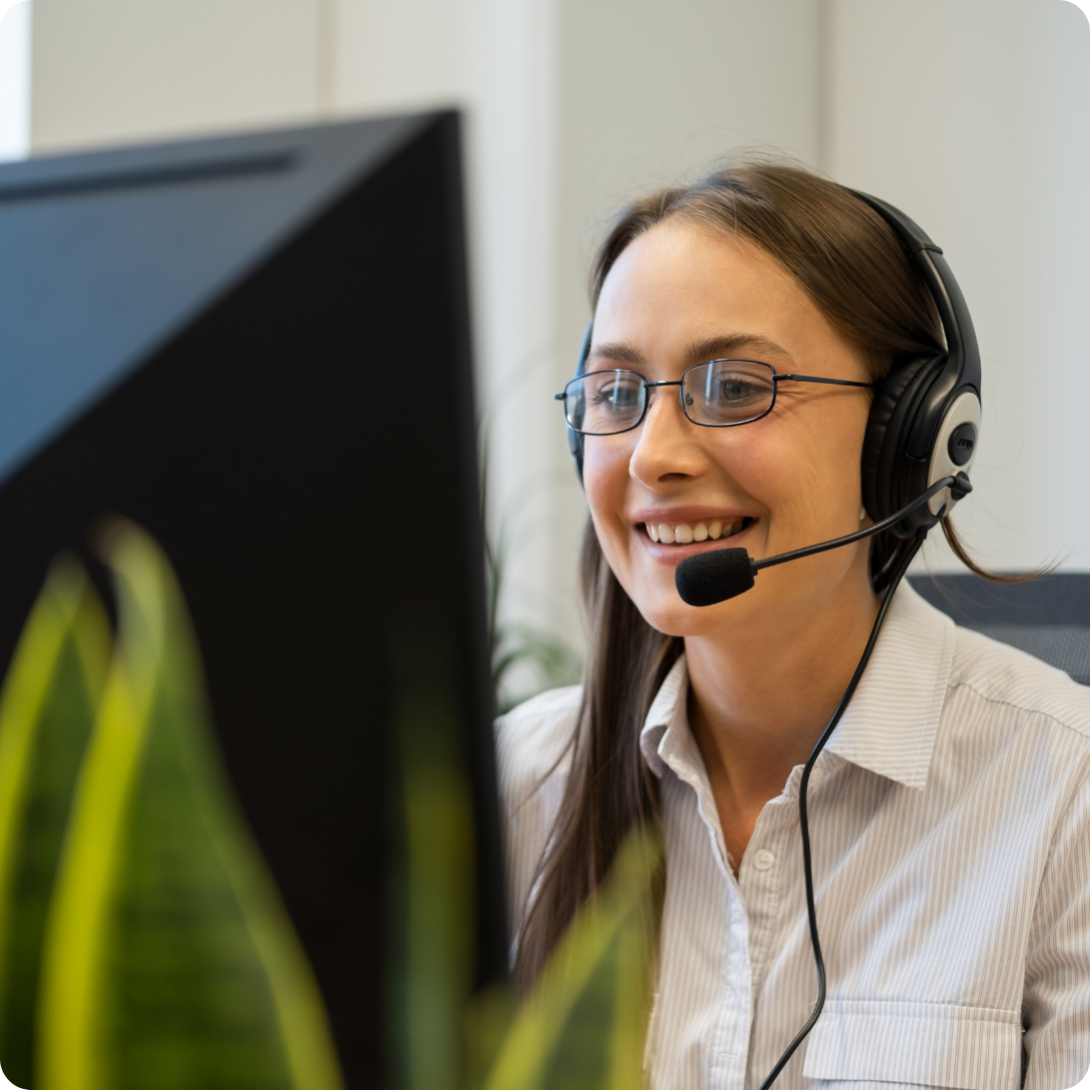 Portrait of the Phonathon Donor persona, a woman wearing a headset at a computer